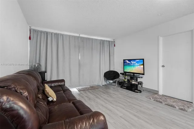 a bedroom with a bed and a wall painting