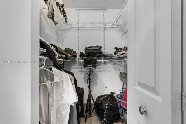 a view of a swimming pool with a lawn chair and palm trees
