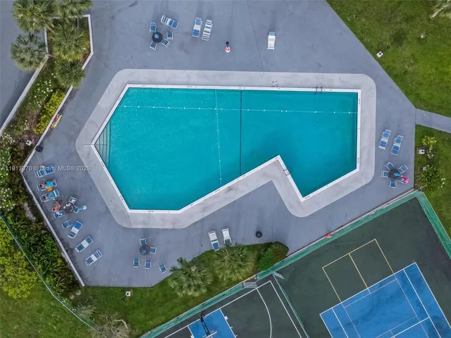 a view of a tall building next to a yard