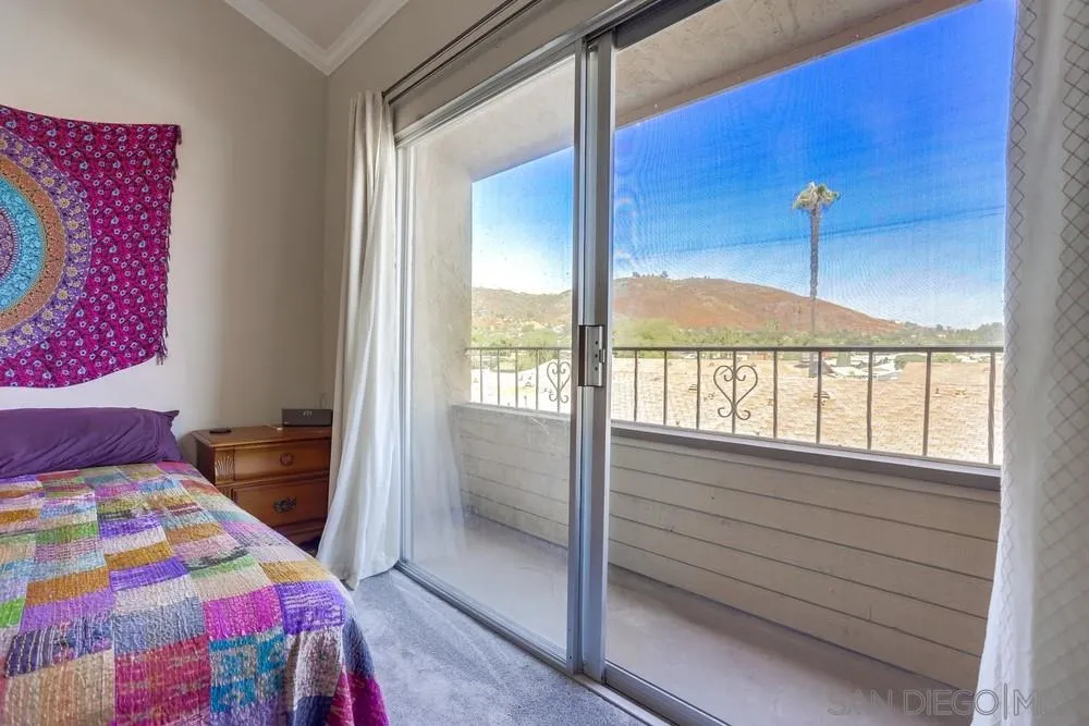1673 Stone Edge Circle El Cajon, CA 92021 - Photo 14 of 20 a bedroom with a bed and a large window