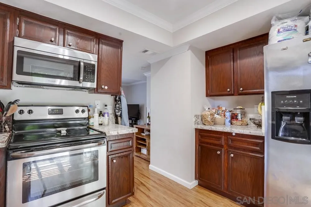 1673 Stone Edge Circle El Cajon, CA 92021 - Photo 8 of 20 a kitchen with stainless steel appliances granite countertop a stove and a microwave