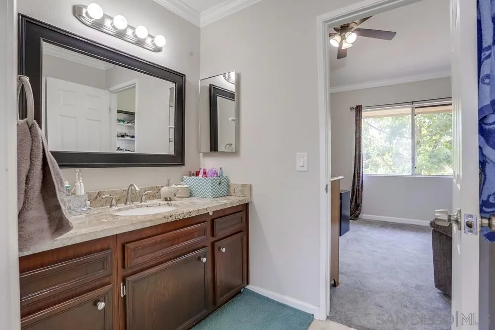 1673 Stone Edge Circle El Cajon, CA 92021 - Photo 9 of 20 a en suite bathroom with a double vanity sink and a mirror
