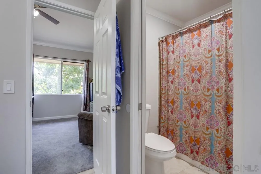 1673 Stone Edge Circle El Cajon, CA 92021 - Photo 10 of 20 a bathroom with a toilet and a shower curtain