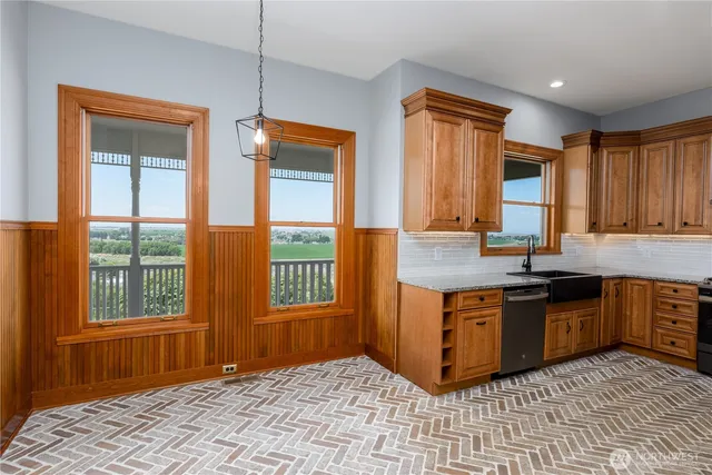 a kitchen with stainless steel appliances granite countertop a stove a sink and a microwave