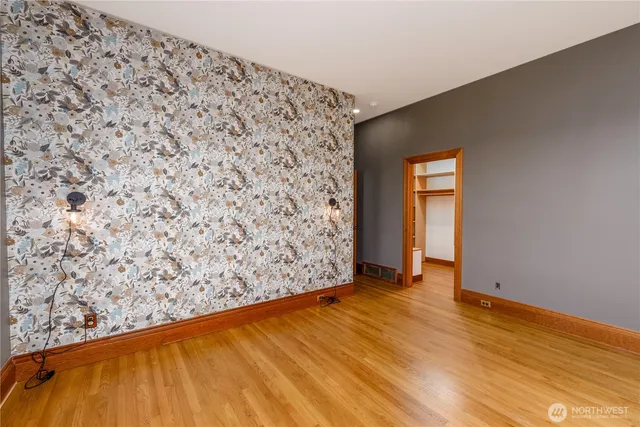 a spacious bathroom with a granite countertop sink a mirror and shower