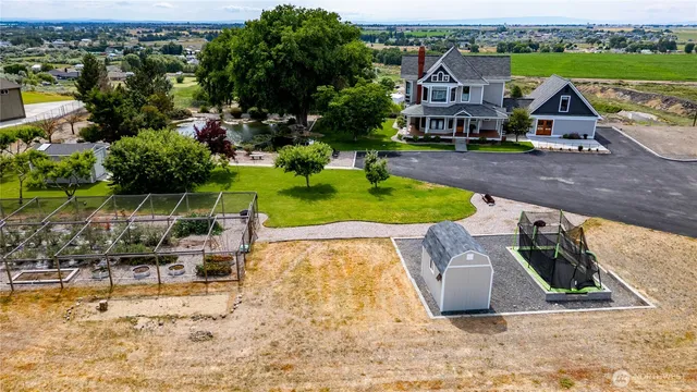 an aerial view of a house with a yard basket ball court and outdoor seating