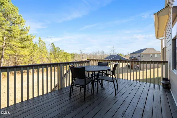a view of a balcony with furniture and wooden floor