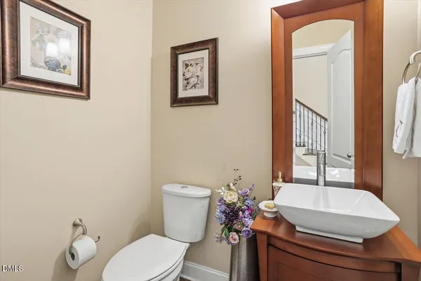 a bathroom with a granite countertop toilet and a sink