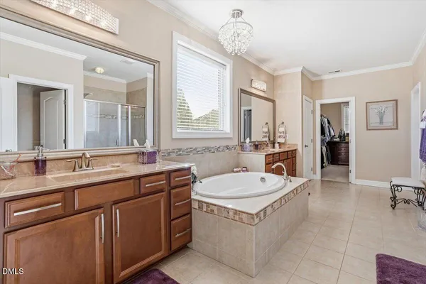 a bathroom with a tub sink and mirror