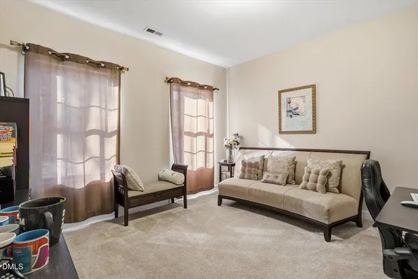 a bedroom with bed couch and window