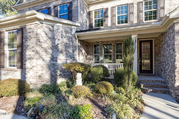 front view of a brick house with a large windows