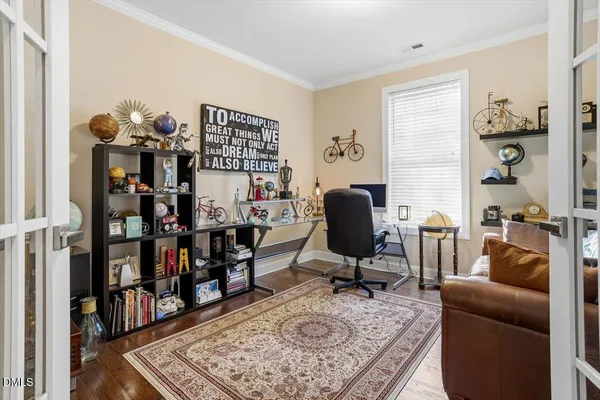 a view of a workspace with furniture and a window