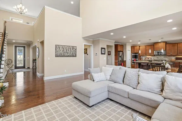 a living room with furniture and kitchen view