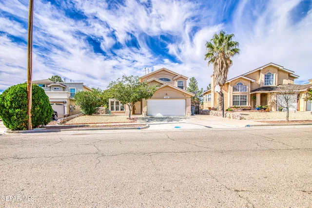 a front view of a house with a yard and a garage