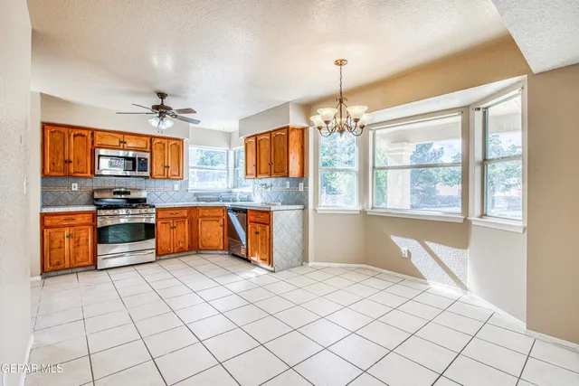 a bathroom with a granite countertop sink a large mirror and a shower