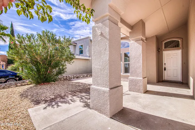 a view of a brick house with potted plants