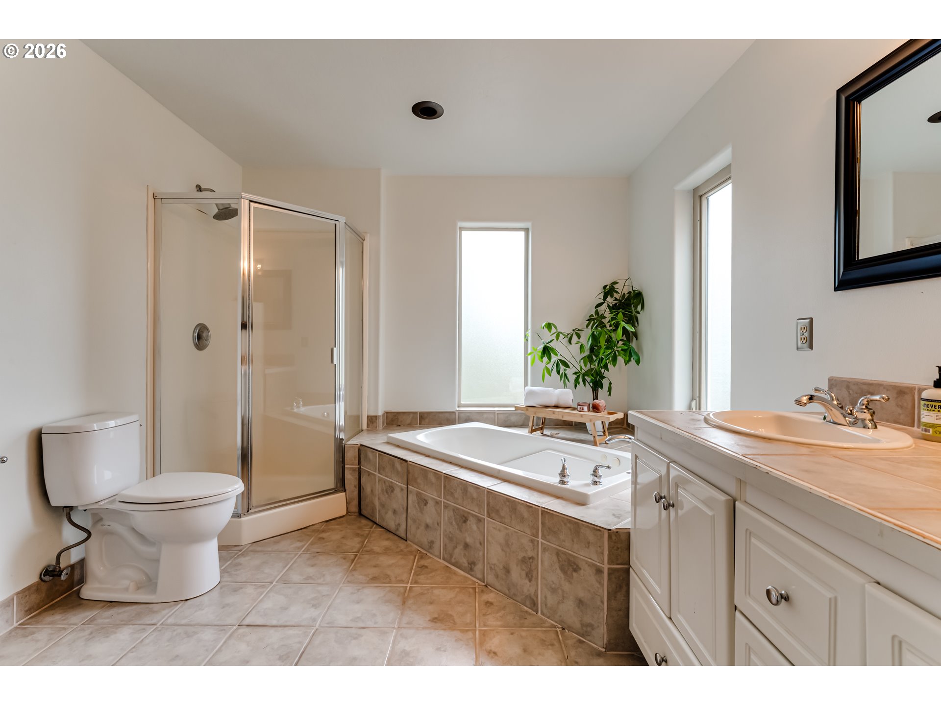 2736 Kismet Way Eugene, OR 97405 - Photo 42 of 48 a spacious bathroom with a granite countertop sink toilet a large mirror a bathtub and shower