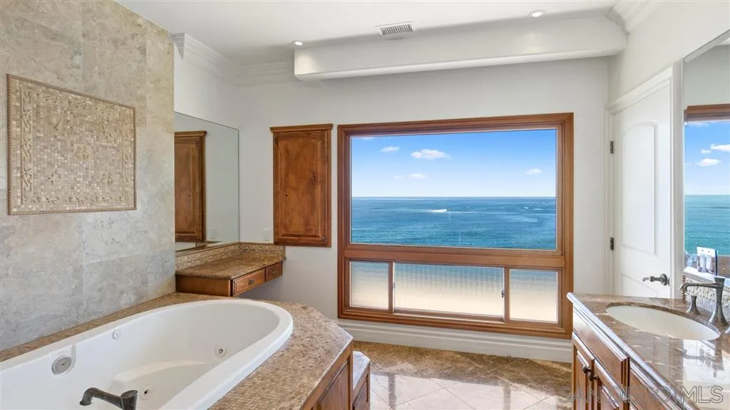 5730 Dolphin Place La Jolla, CA 92037 - Photo 9 of 19 a bathroom with a tub sink and mirror
