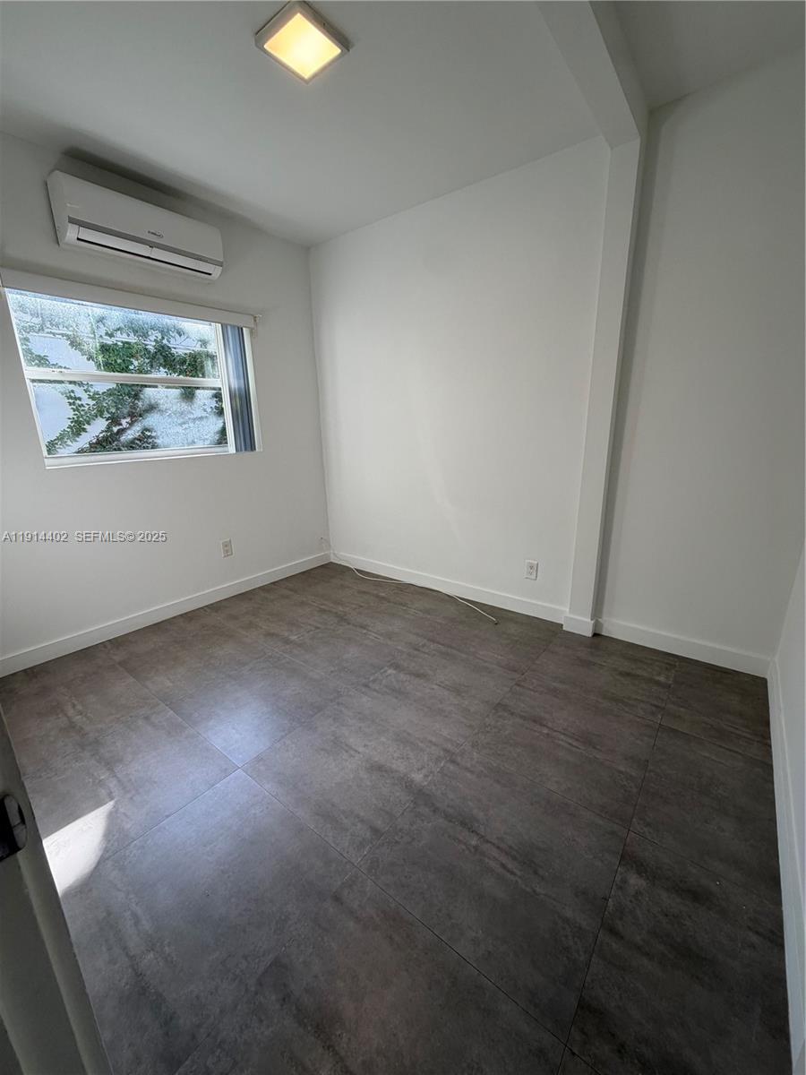 3051 Southwest 27th Lane, Unit 3 Miami, FL 33133 - Photo 7 of 8 an empty room with a window