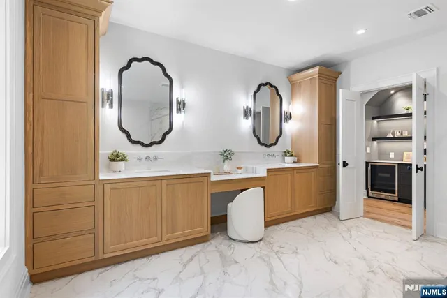 a spacious bathroom with a double vanity sink and a mirror