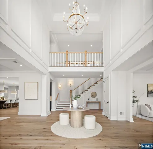 a view of a living room and chandelier with furniture