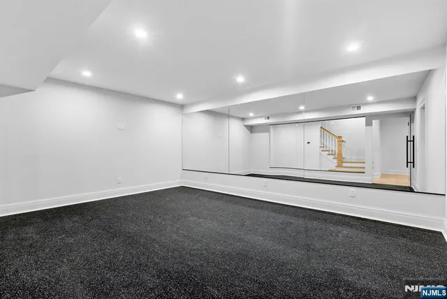 an empty room with wooden floor and window