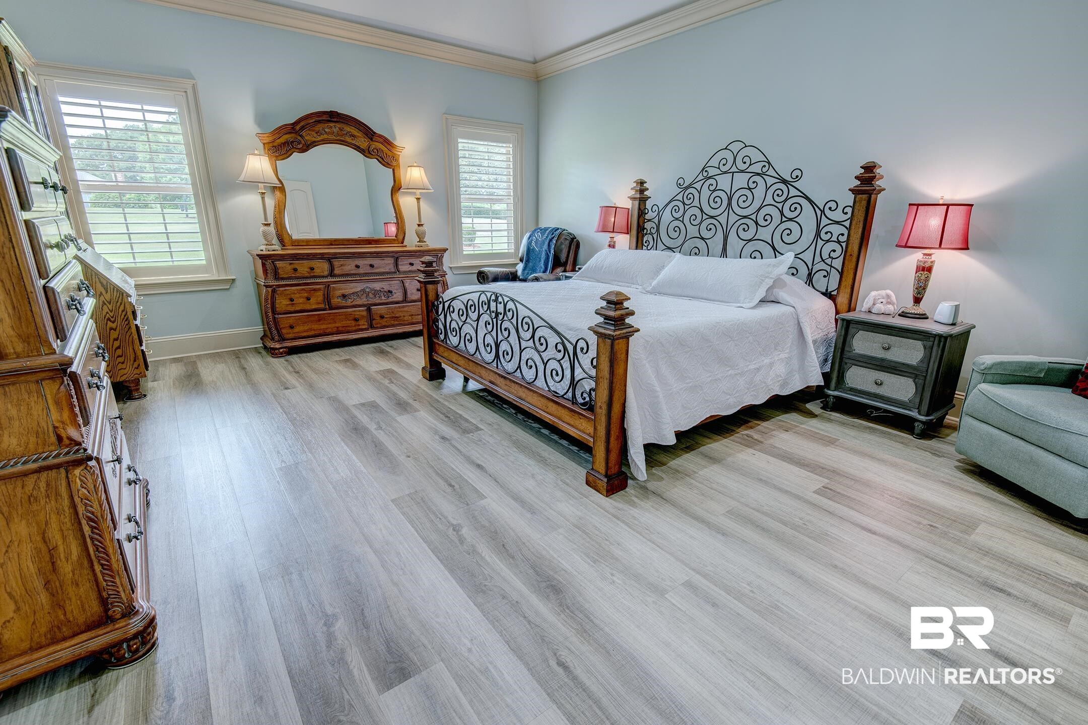 9357 Lakeview Drive Foley, AL 36535 - Photo 44 of 68 Light wood-finish flooring with a subtle grain pattern, leading to white plantation shutters on multiple windows