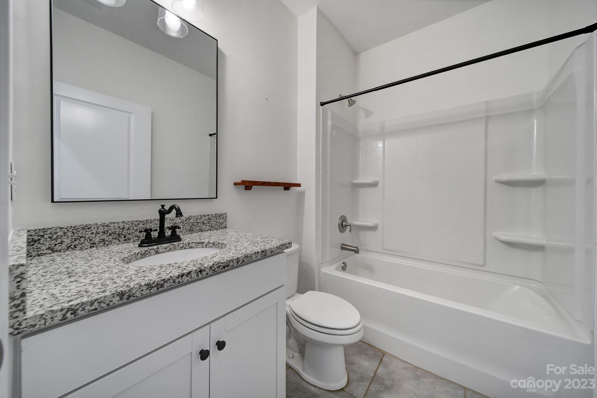 5072 Gribble Lane Lancaster, SC 29720 - Photo 13 of 34 a bathroom with a granite countertop sink toilet and shower