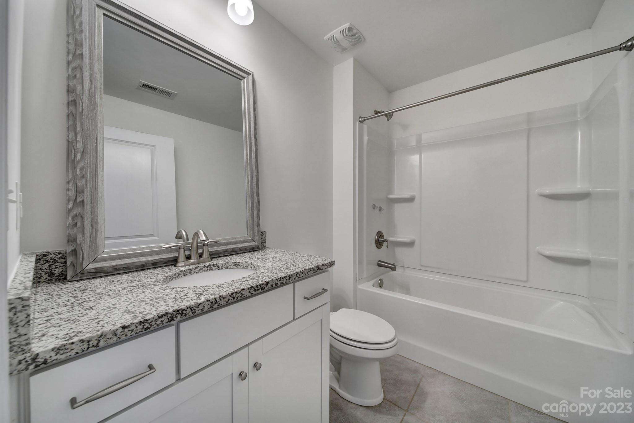 5072 Gribble Lane Lancaster, SC 29720 - Photo 19 of 34 a bathroom with a granite countertop bathtub shower sink vanity and toilet