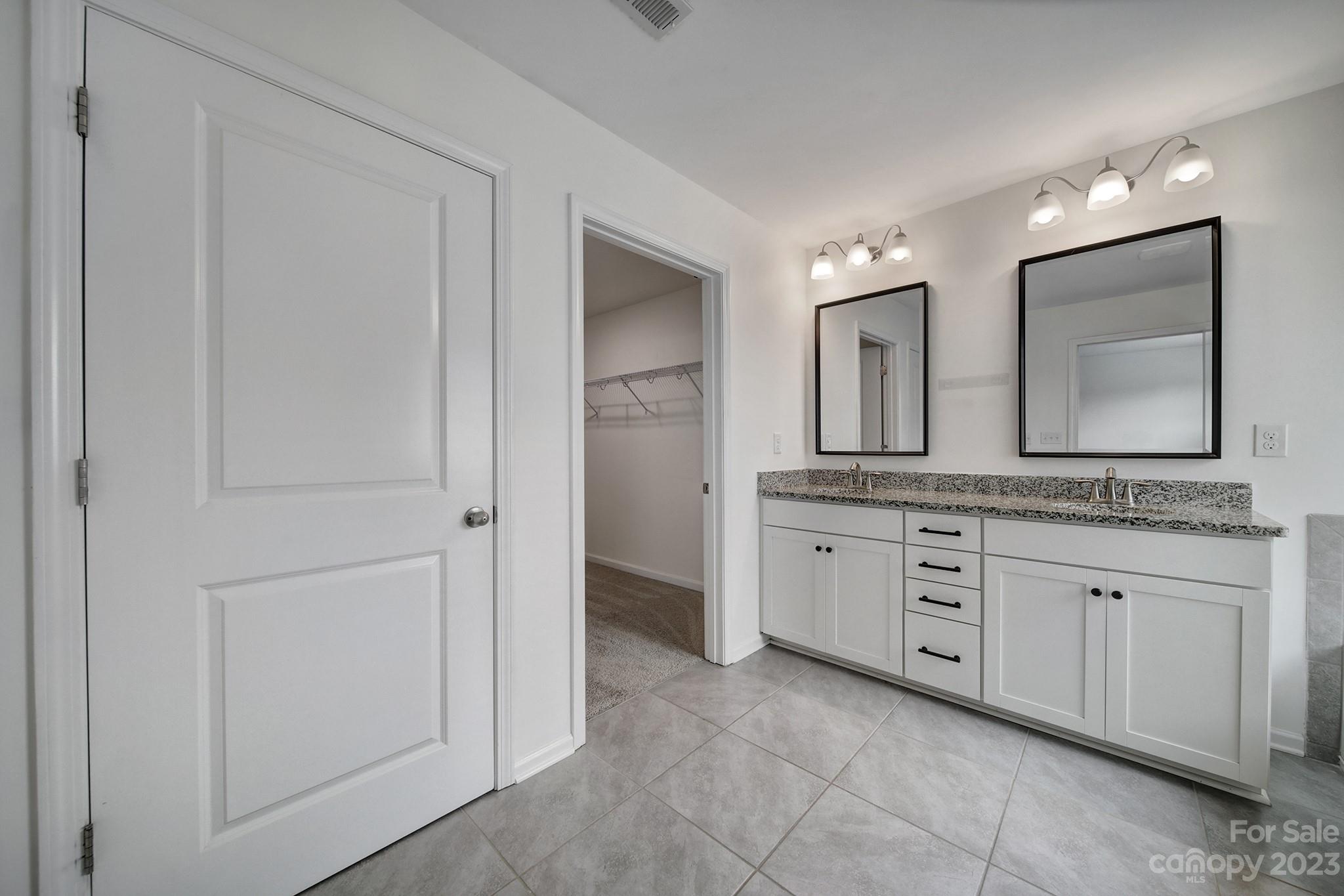 5072 Gribble Lane Lancaster, SC 29720 - Photo 26 of 34 a bathroom with a granite countertop sink two mirror and a mirror