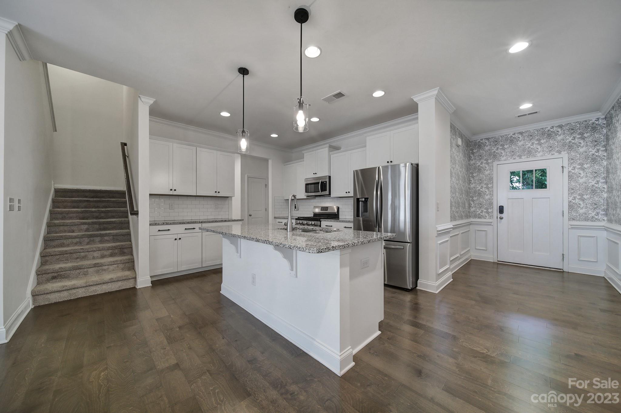 5072 Gribble Lane Lancaster, SC 29720 - Photo 5 of 34 a kitchen with white cabinets and stainless steel appliances