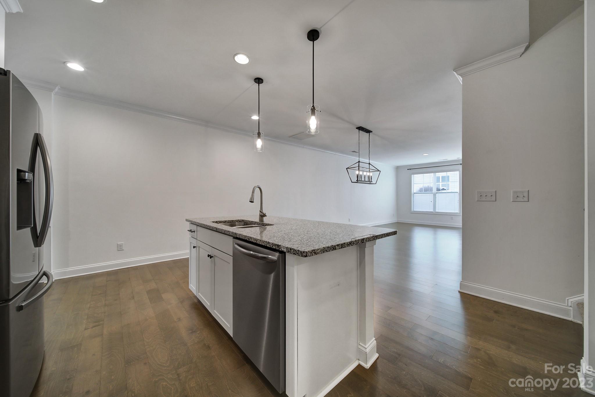5072 Gribble Lane Lancaster, SC 29720 - Photo 6 of 34 a kitchen with stainless steel appliances granite countertop a sink a stove and a wooden floor