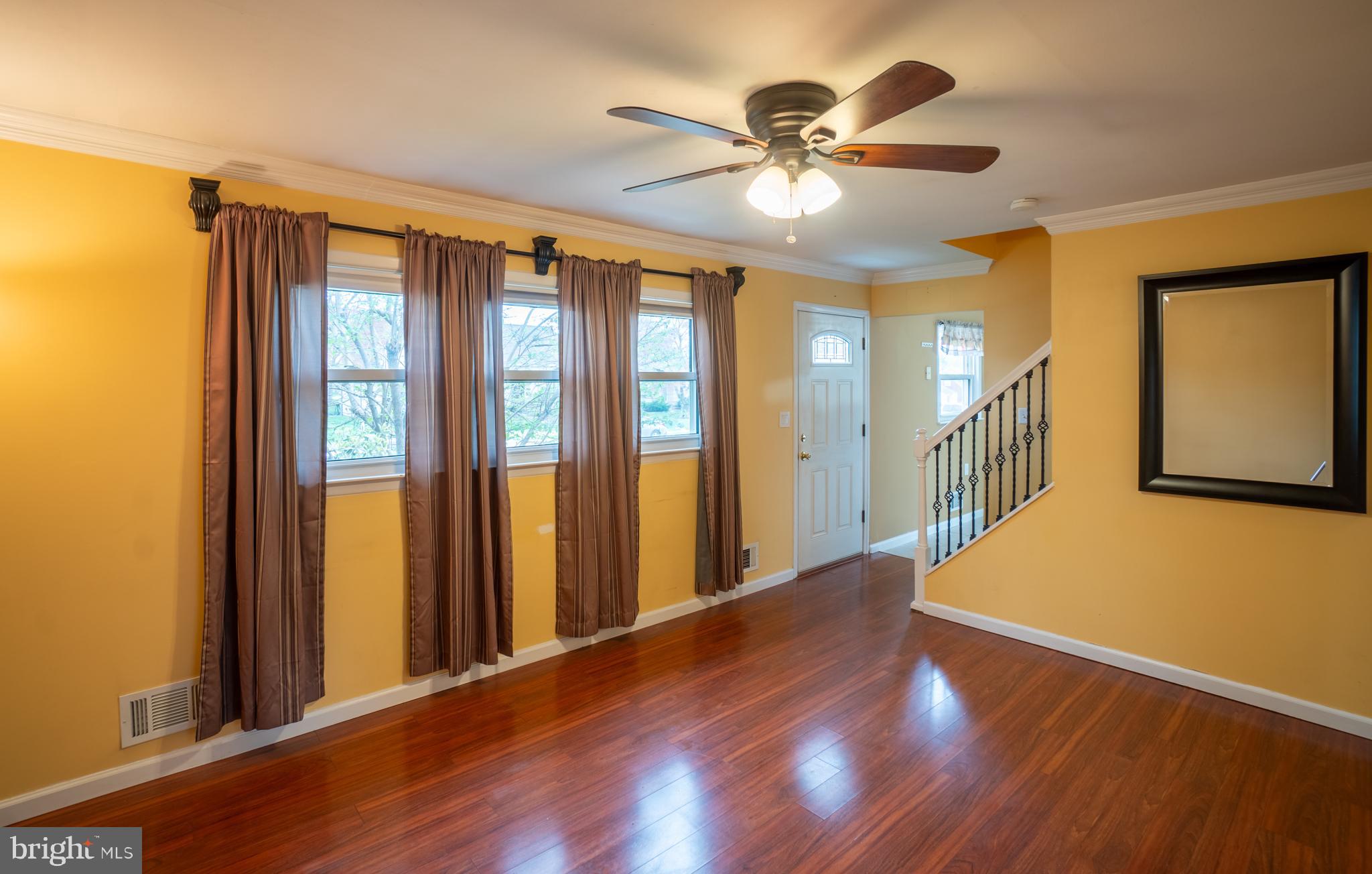 32 Coleridge Avenue Hamilton, NJ 08620 - Photo 5 of 22 a view of a hallway with wooden floor and chandelier