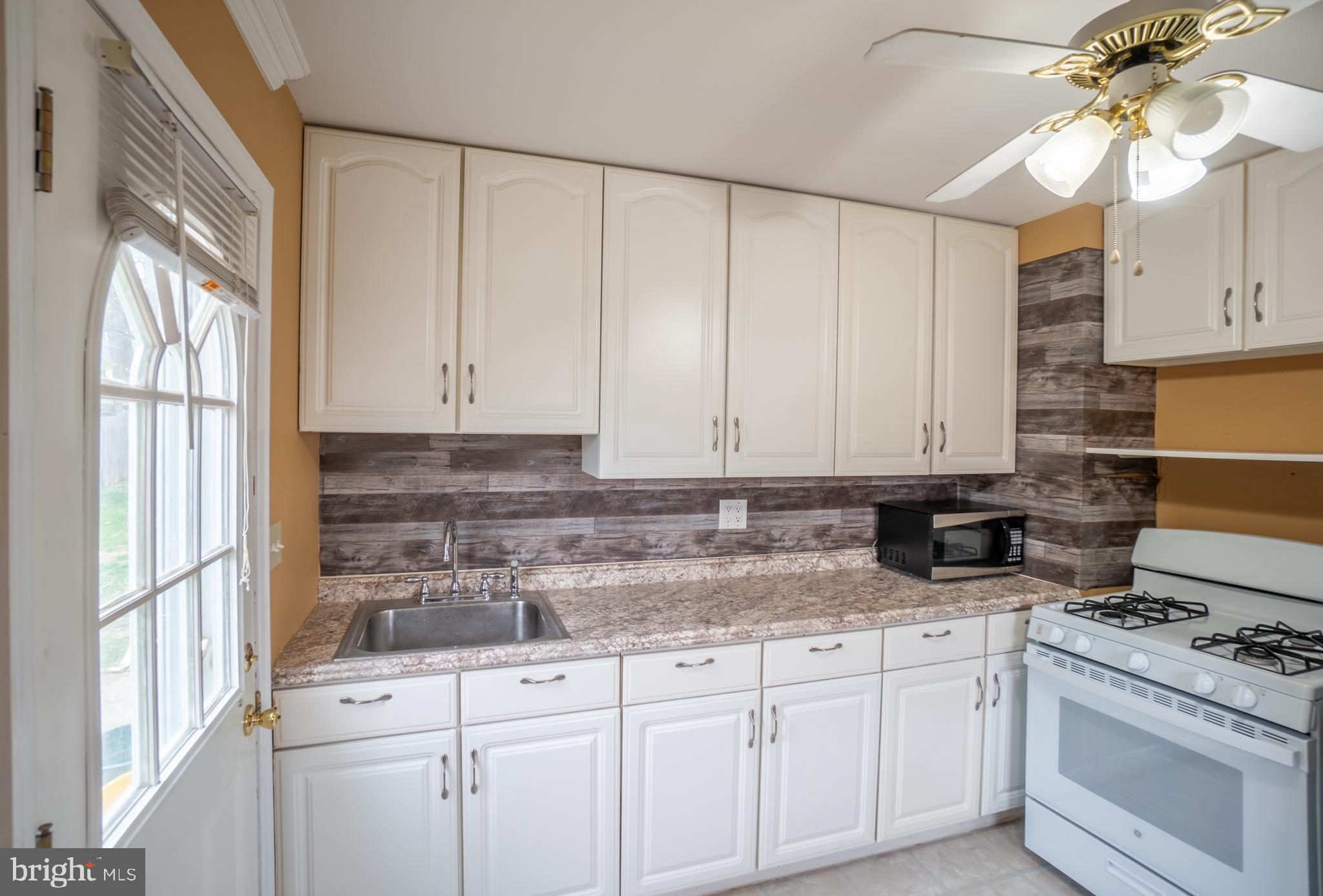 32 Coleridge Avenue Hamilton, NJ 08620 - Photo 6 of 22 a kitchen with granite countertop white cabinets and white appliances