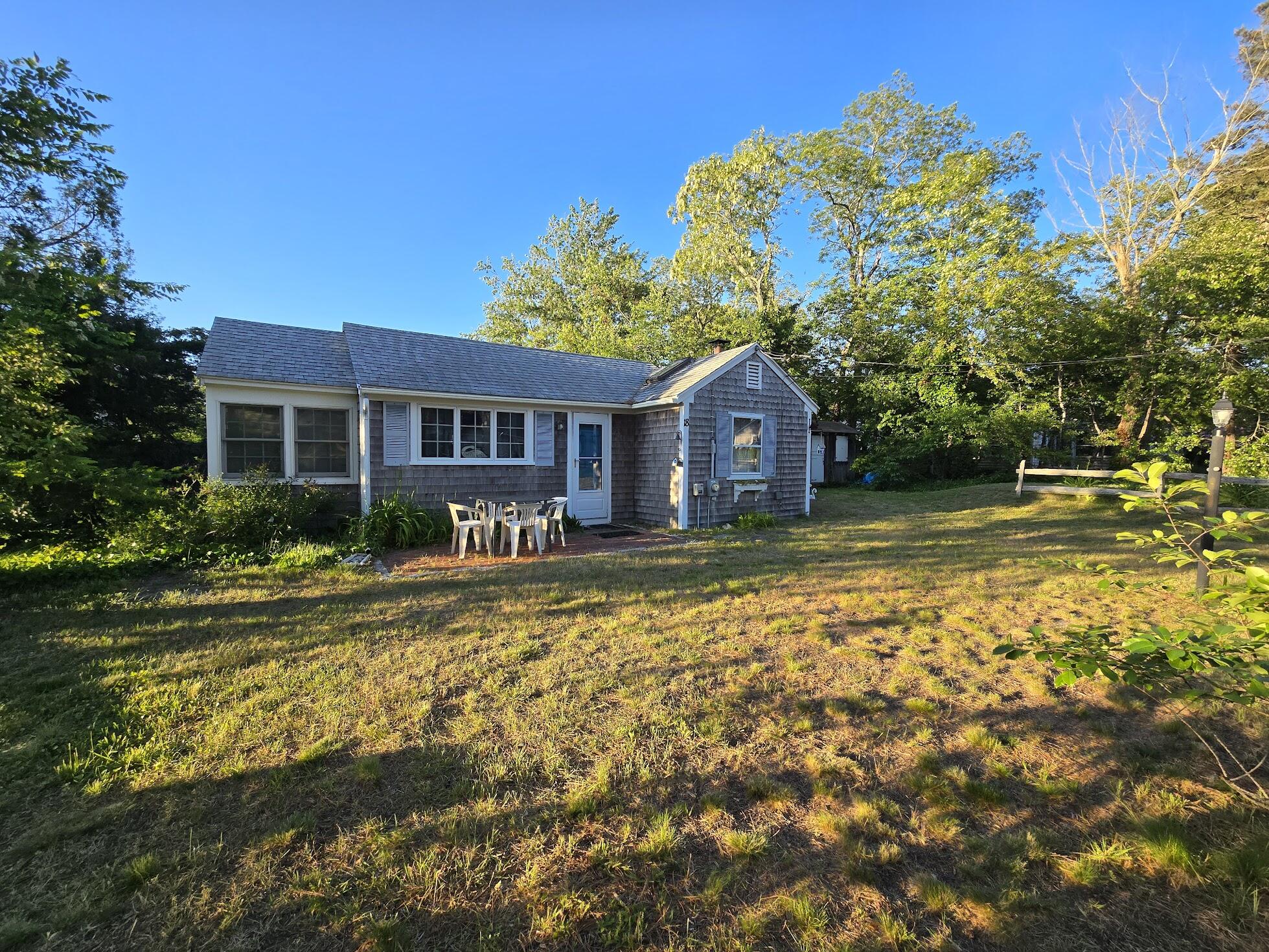 18 Myrtle Lane Dennis Port, MA 02639 - Photo 1 of 25 a front view of a house with a garden
