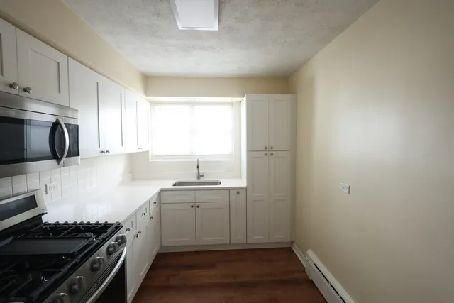 a kitchen with a sink and a stove top oven