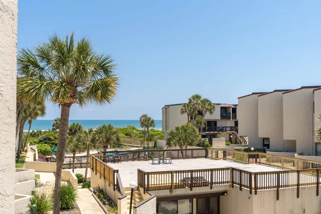 a view of a swimming pool with outdoor seating and plants
