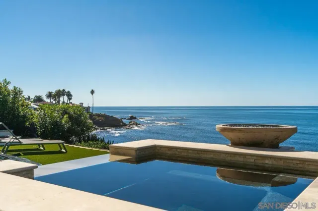 a view of a swimming pool with an outdoor space and seating area