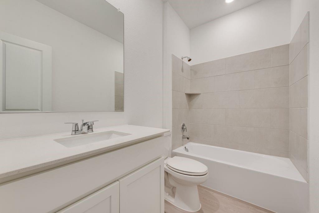 3009 Dutch Road Providence Village, TX 76227 - Photo 10 of 19 a bathroom with a sink a toilet and shower
