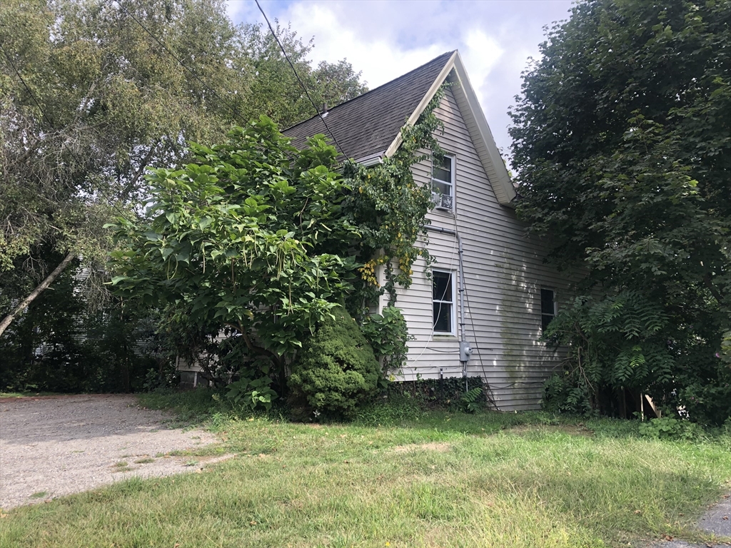 96 Cherry Street Whitman, MA 02382 - Photo 3 of 6 a view of a house with a yard and plants