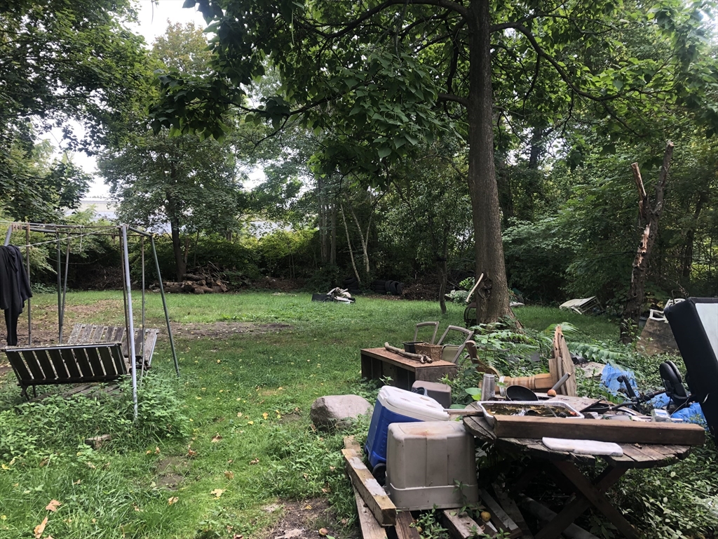 96 Cherry Street Whitman, MA 02382 - Photo 6 of 6 a backyard of a house with table and chairs