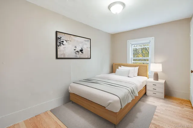 a bedroom with a bed and a wall painting