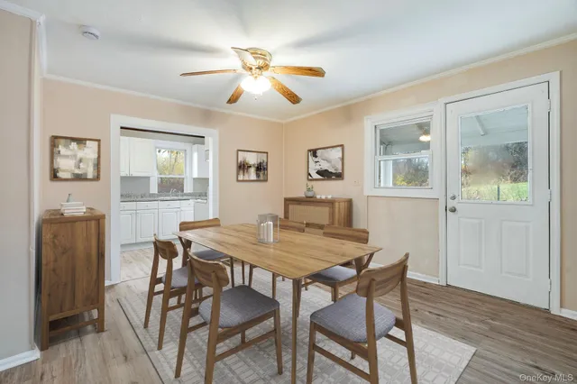 a view of a dining room with furniture and wooden floor