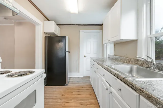 a kitchen with a sink stove and refrigerator
