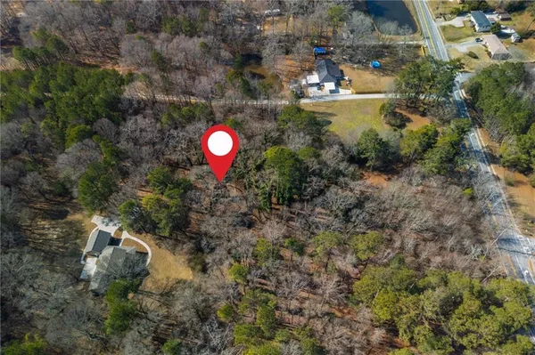 a aerial view of a house with a yard and lake view