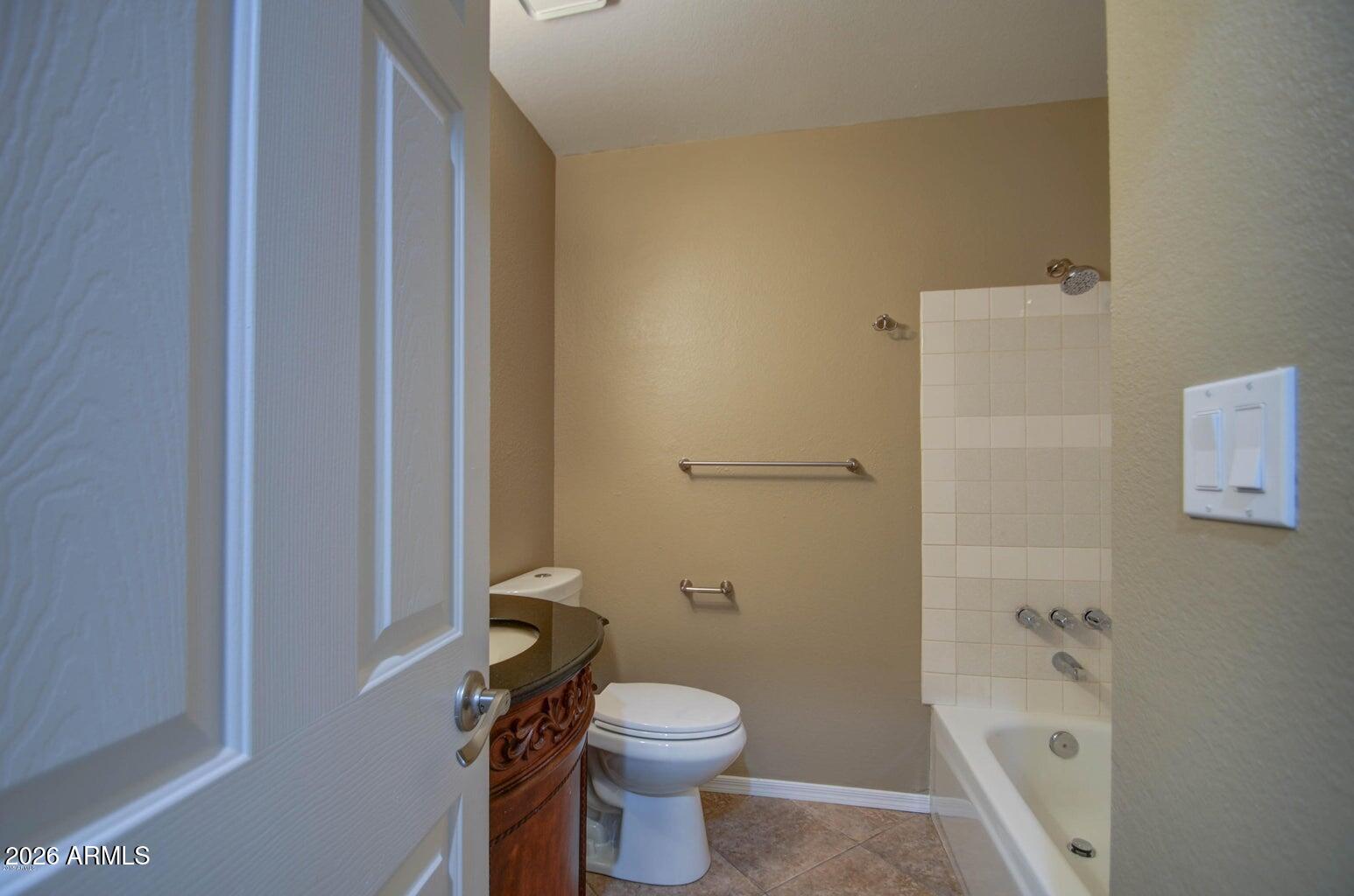 3022 North 34th Place Phoenix, AZ 85018 - Photo 19 of 40 a white toilet sitting next to a bathroom sink and vanity