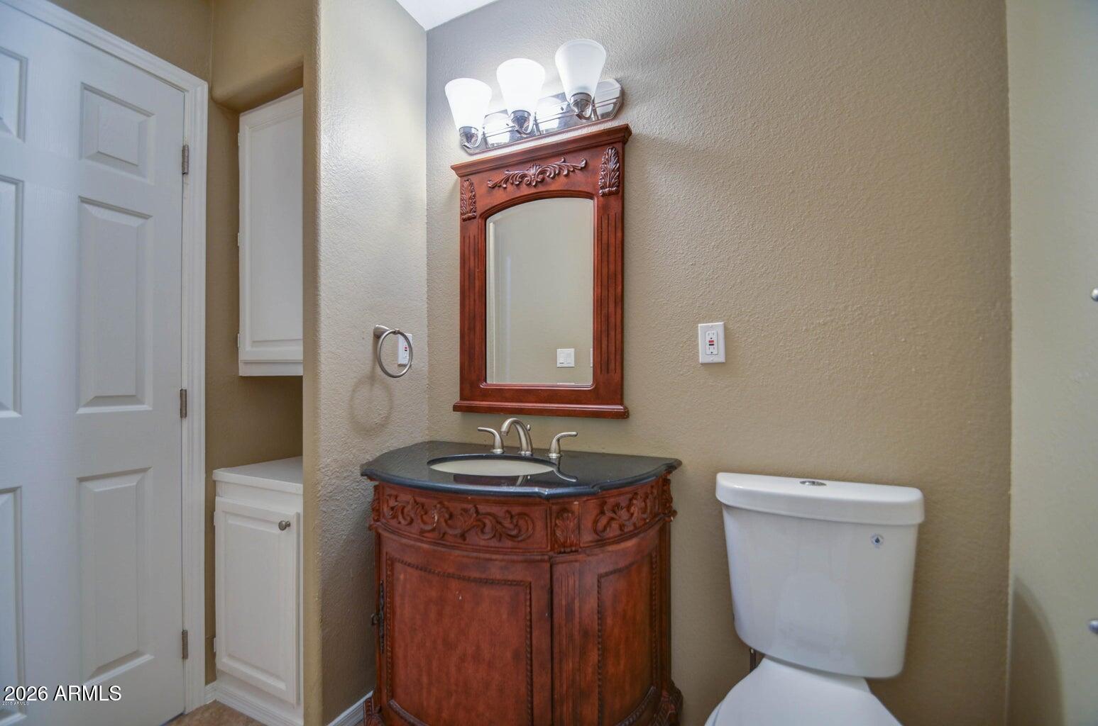 3022 North 34th Place Phoenix, AZ 85018 - Photo 20 of 40 a bathroom with a granite countertop toilet sink and mirror