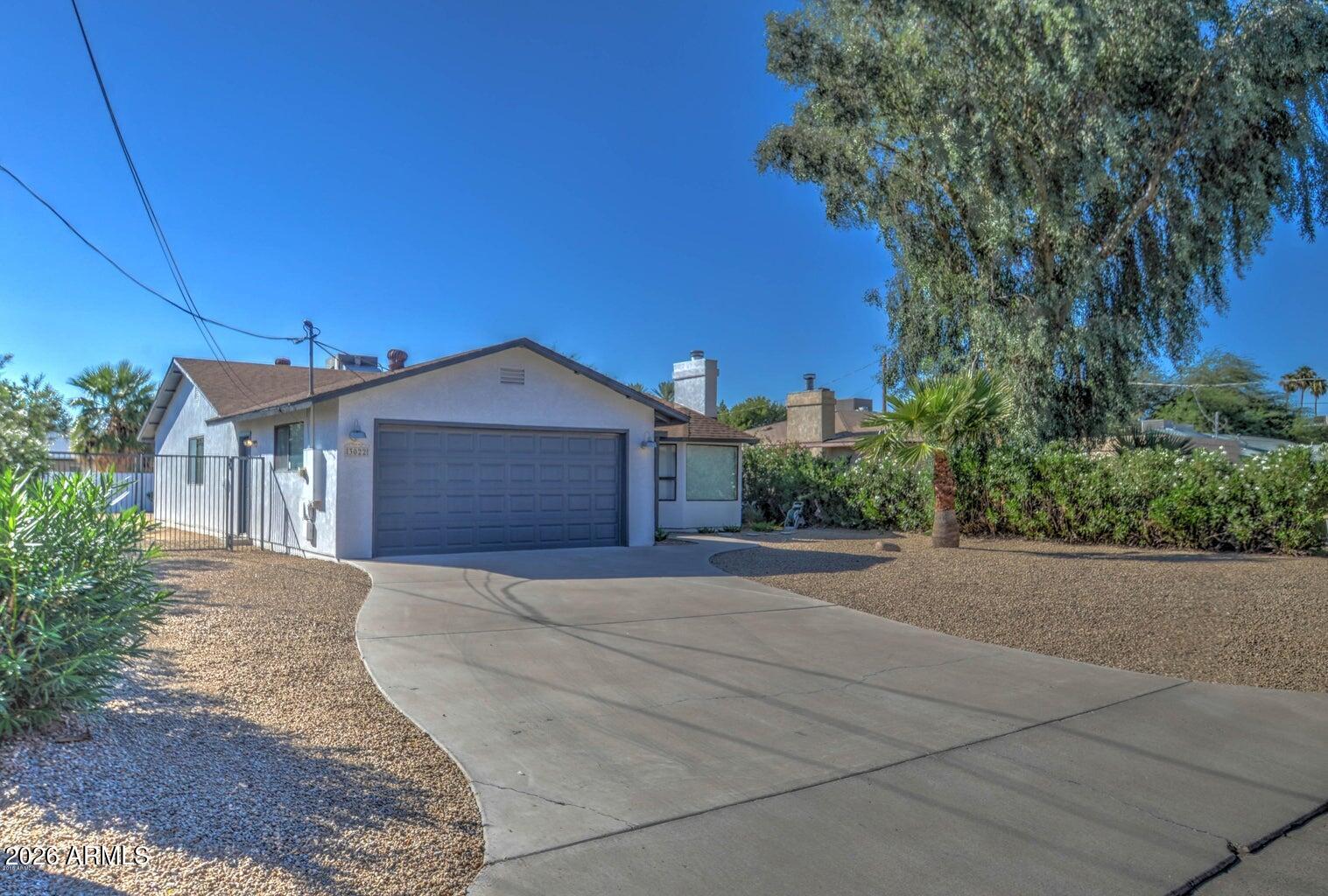 3022 North 34th Place Phoenix, AZ 85018 - Photo 2 of 40 a front view of a house with a yard and garage
