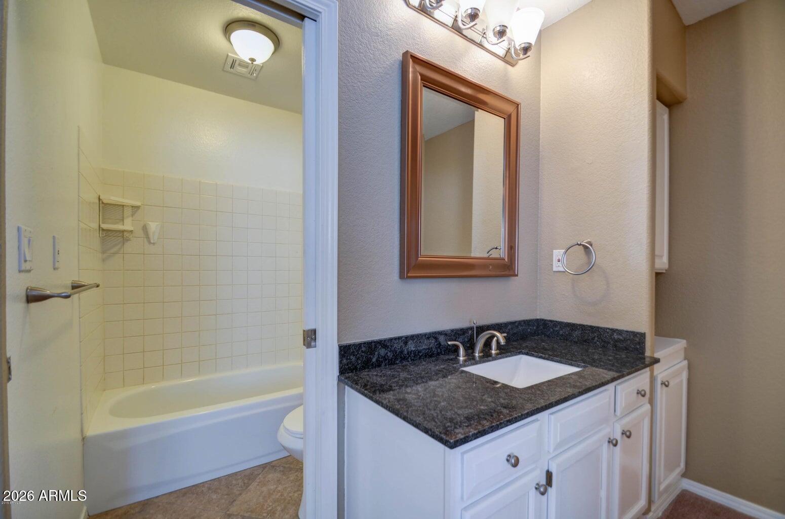 3022 North 34th Place Phoenix, AZ 85018 - Photo 29 of 40 a bathroom with a granite countertop sink and a mirror