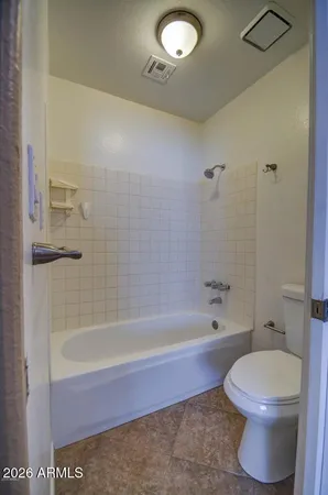a bathroom with a bathtub and toilet